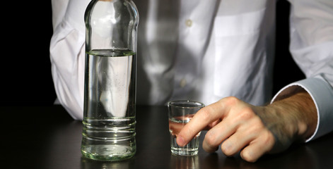 Man with bottle of alcohol,  on black background