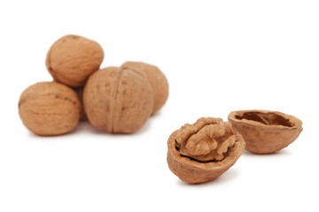 Several full and cracked walnuts (isolated)