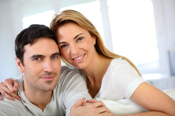 Portrait of in love couple sitting in sofa