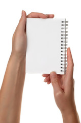 Hands holding white notebook