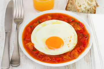 fried egg with vegetables, bread and juice