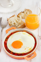 fried egg with vegetables and orange juice