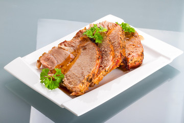Slices of homemade roast pork on the plate