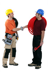 Electrician and plumber shaking hands