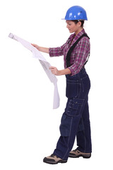 Female worker reading through building plans