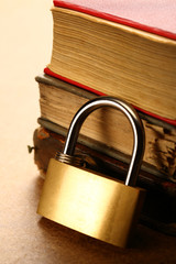Naklejka premium Pile of old books and keylock