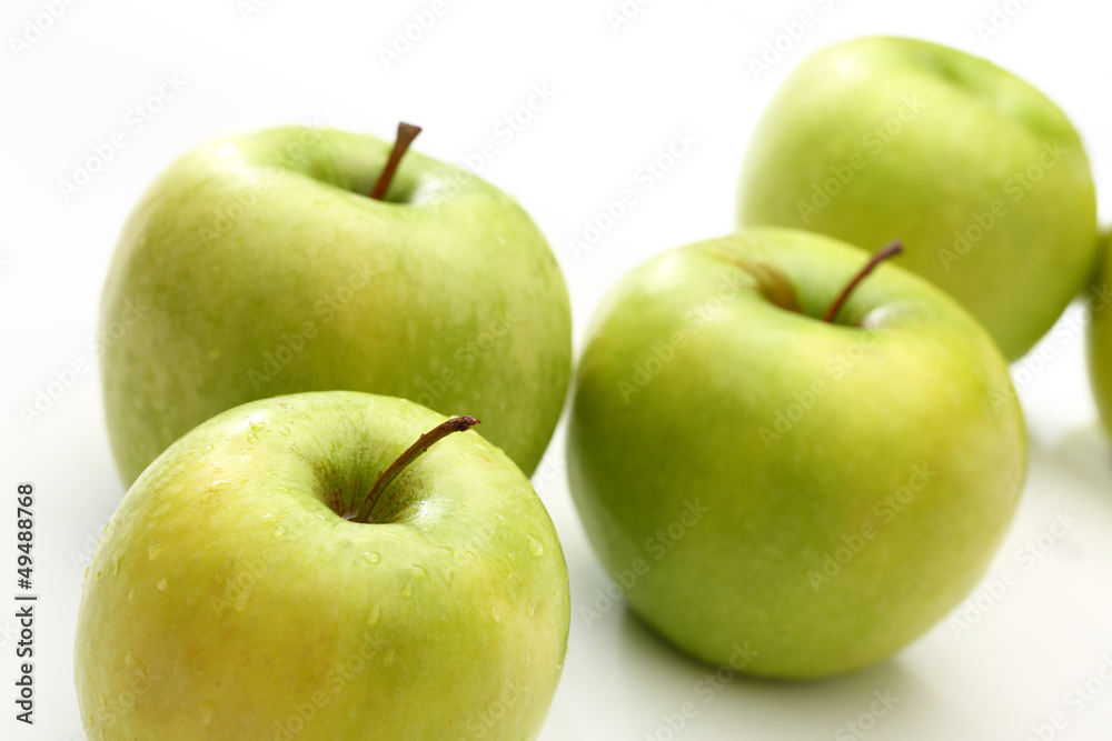 Wall mural Green apples on white background