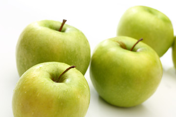 Green apples on white background