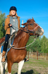 A woman riding a horse