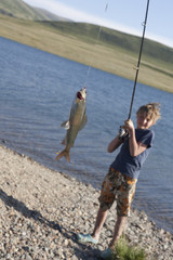 The boy with a spinning catch grayling