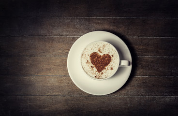 Cup with coffee and shape of the cacao heart on it.