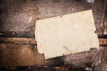 Damaged paper sheet on wood