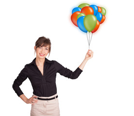 Young woman holding colorful balloons