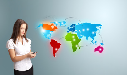 Young woman holding a phone and presenting colorful world map