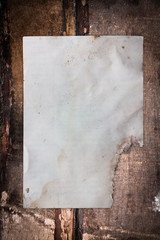 Old damaged paper sheet on a dark background