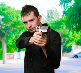 Fototapeta premium Portrait Of A Man Holding Gun