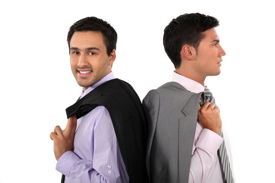 Two businessmen with jackets over shoulders