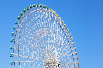Ferris wheel in blue sky