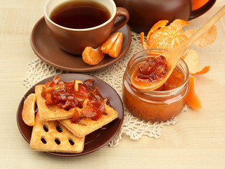 light breakfast with tea and homemade jam, on wooden table