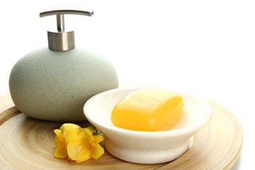 Bottle and soap-dish with soap isolated on white
