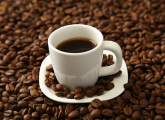 Cup of coffee on coffee beans background