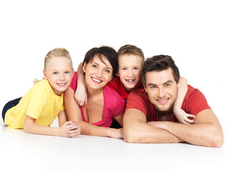 happy family with two children lying on white floor