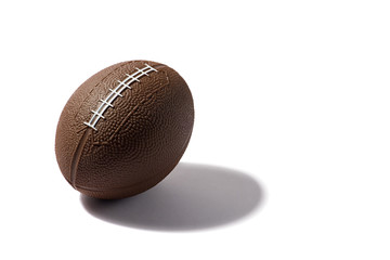 Football on white background with hard shadow