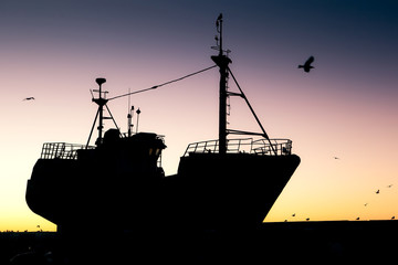 Fishing vessel silhouette at sunset