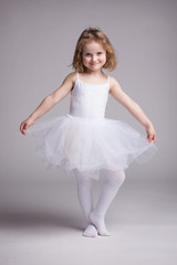 Naklejka premium Happy little girl in dress ballerina
