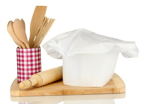 Chef's hat with spoons and battledore isolated on white