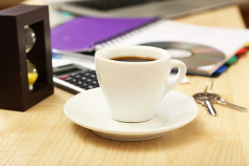 Cup of coffee on office desktop close-up