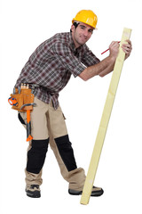 craftsman measuring a board