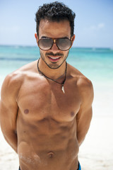 Portrait of an attractive young man on a tropical beach