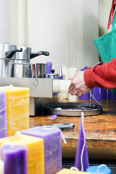 Candle maker at work in a candle manufacture