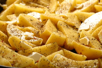 Raw potatoes with spices ready to be roasted