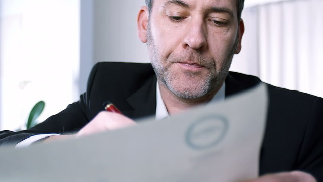Businessman signs a contract - tracking shot