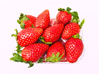 Fresh Strawberry piled in clear plastic box Isolated on white ba