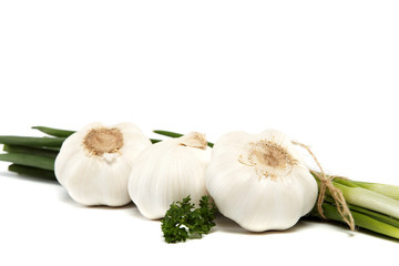 Fresh green onions, garlic and parsley isolated on white.