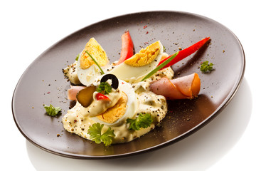 Boiled eggs with mayonnaise and vegetables