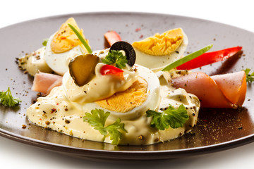 Boiled eggs with mayonnaise and vegetables
