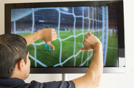 man watching football with your finger down- thumbs down