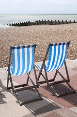 Two Striped Deck Chairs at The Seaside