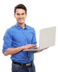 Portrait of young man holding laptop