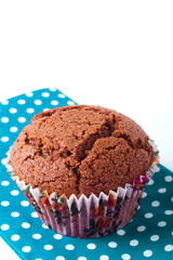 homemade baked chocolate chip muffin with blue napkin