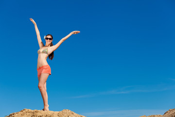 Portrait of young woman in bikini at beach