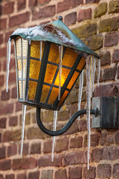 Antique lantern covered with icicles
