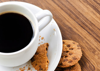 Coffee and oatmeal cookies on wooden table