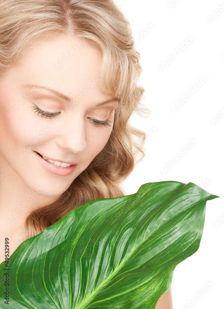 Wall mural woman with green leaf