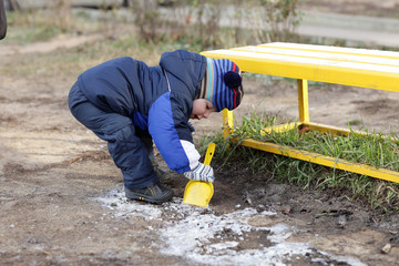 Toddler playing with shovel