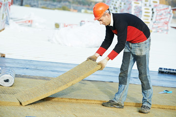 roofer worker installing roof insulation material - obrazy, fototapety, plakaty